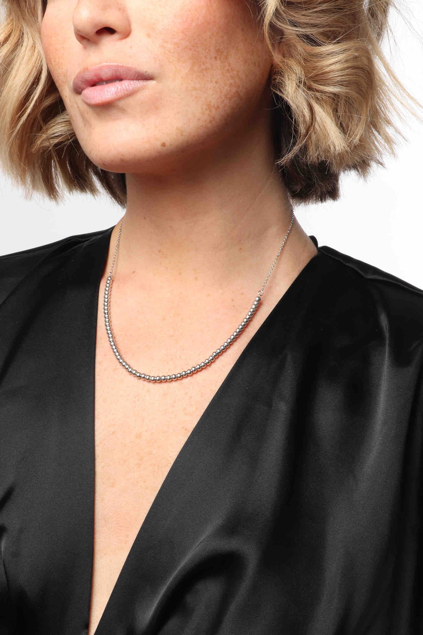 Marrin Costello wearing Marrin Costello Jewelry Crown Chain dainty dot necklace with lobster clasp closure and extender. Waterproof, sustainable, hypoallergenic. Polished stainless steel.