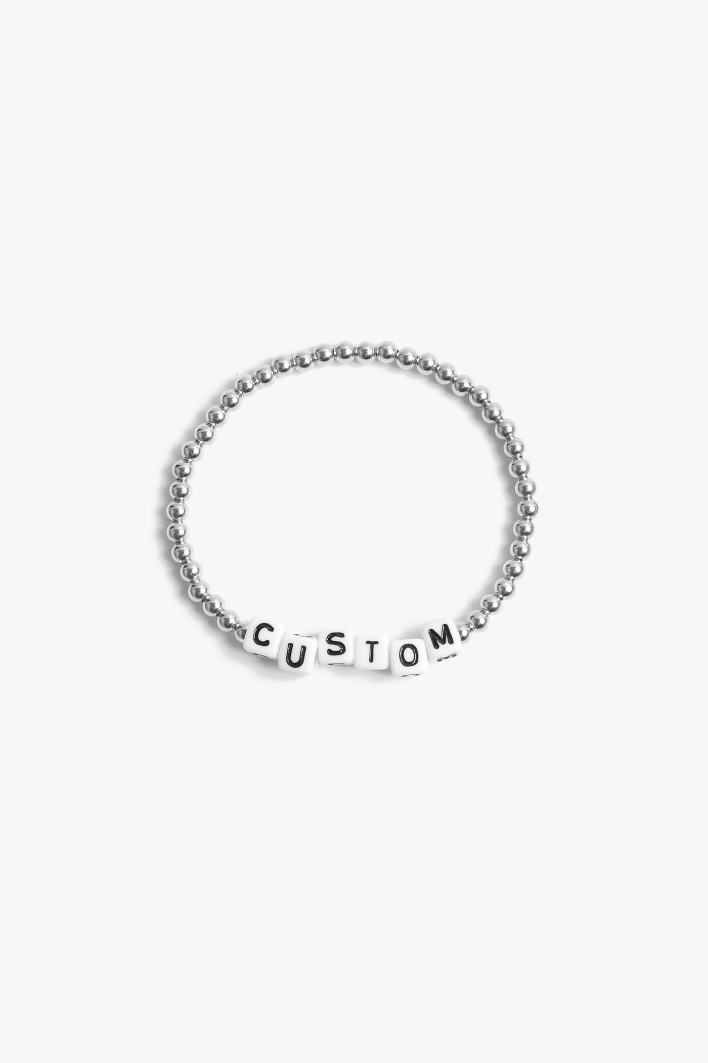 Marin Costello Jewelry Crown Letter Bracelet beaded block letter bracelet, customizable. White block letters, silver beads. Waterproof, sustainable, hypoallergenic. Polished stainless steel.