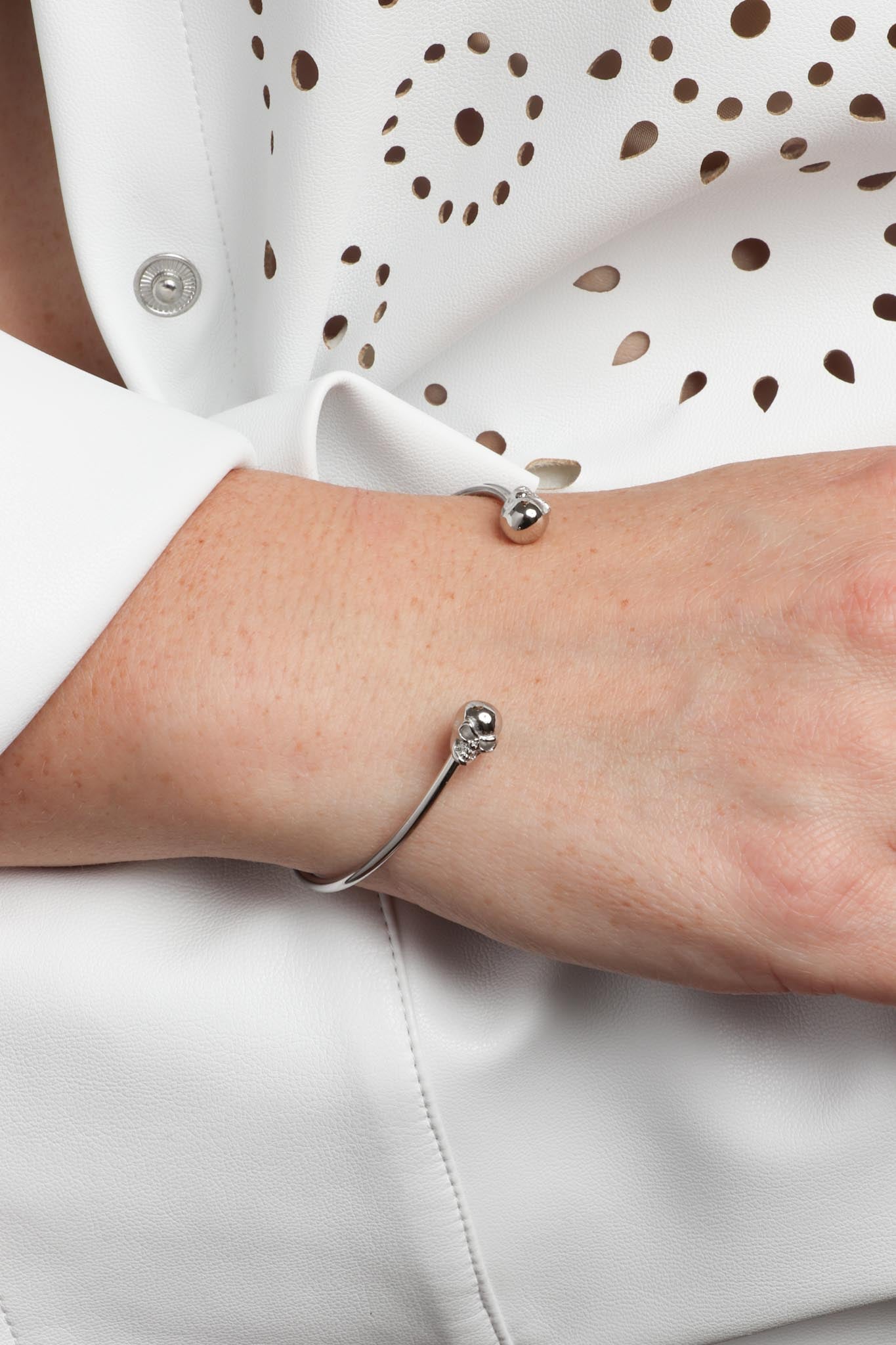 Marrin Costello wearing Marrin Costello Jewelry Hyde Cuff skull adjustable bracelet with cuff bracelet opening. Waterproof, sustainable, hypoallergenic. Polished stainless steel.