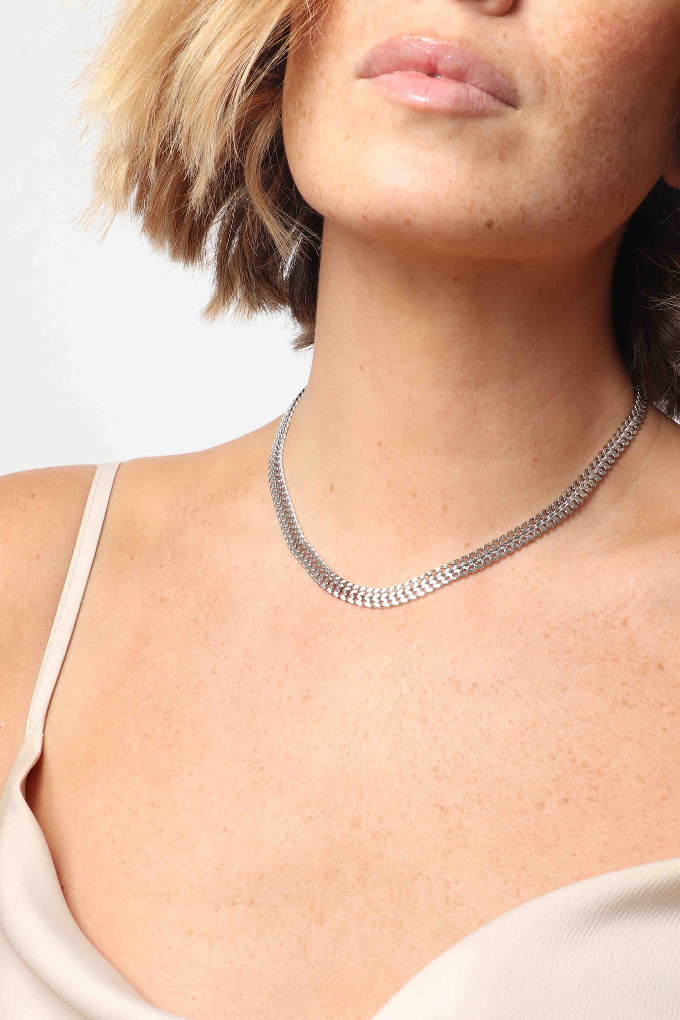 Marrin Costello wearing Marrin Costello Jewelry Lattice Choker woven chain edgy necklace with lobster clasp closure and extender. Waterproof, sustainable, hypoallergenic. Polished stainless steel.
