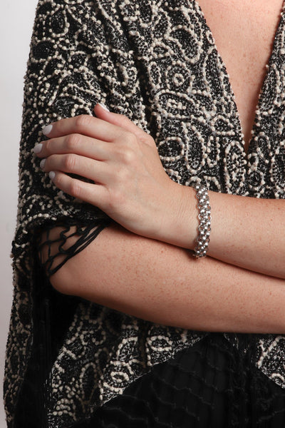 Marrin Costello wearing Marrin Costello Jewelry Lattice XL Bracelet woven chain bracelet with lobster clasp closure. Waterproof, sustainable, hypoallergenic. Polished stainless steel.