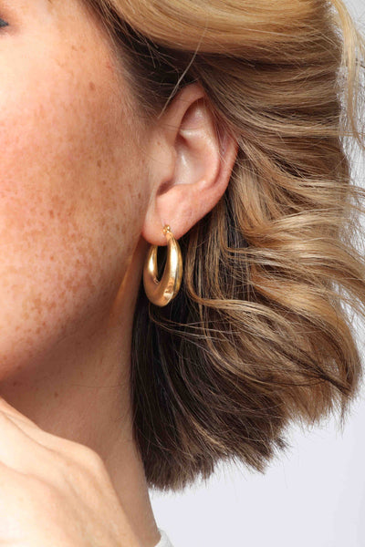 Marrin Costello wearing Marrin Costello Jewelry Layla Hoops click back closure earrings — for pierced ears. Waterproof, sustainable, hypoallergenic. 14k gold plated stainless steel.