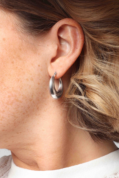 Marrin Costello wearing Marrin Costello Jewelry Layla Hoops click back closure earrings — for pierced ears. Waterproof, sustainable, hypoallergenic. Polished stainless steel.