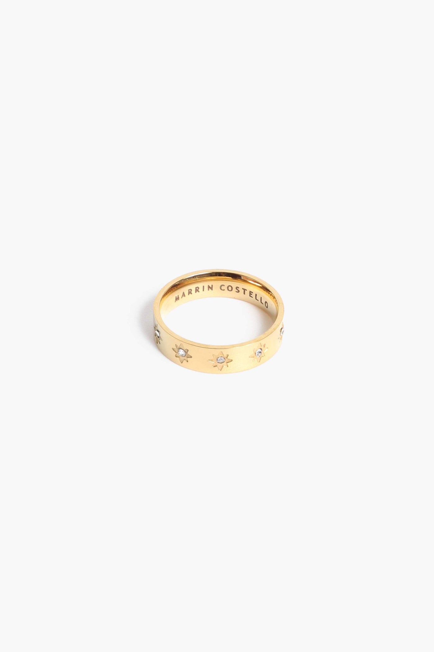 Marrin Costello Jewelry Orion Band star motif ring with CZ detail. Available in sizes 6, 7, 8. Waterproof, sustainable, hypoallergenic. 14k gold plated stainless steel.
