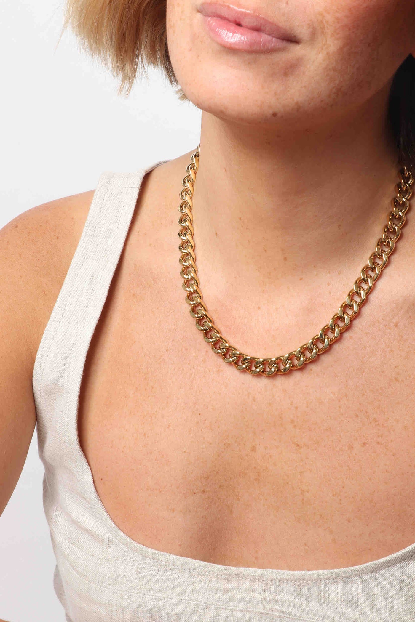 Marrin Costello wearing Marrin Costello Jewelry Queens Chain chunky statement cuban link chain necklace with lobster clasp closure. Waterproof, sustainable, hypoallergenic. 14k gold plated stainless steel.