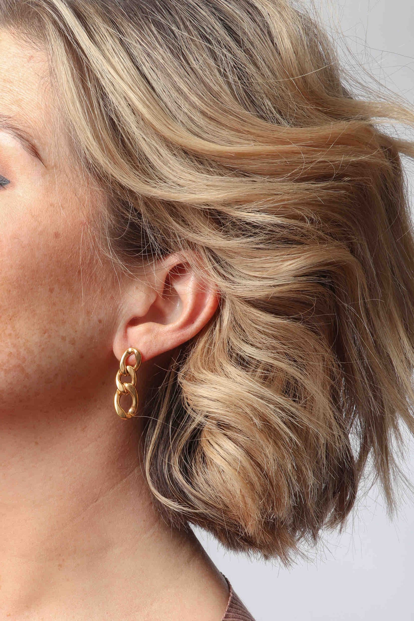 Marrin Costello wearing Marrin Costello Jewelry Queens XL Drops large cuban link post back earrings — for pierced ears. Waterproof, sustainable, hypoallergenic. 14k gold plated stainless steel.
